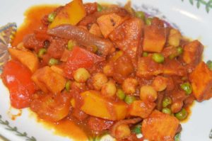 chickpea, sweet potato, pepper and pea curry on a plate