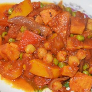chickpea, sweet potato, pepper and pea curry on a plate