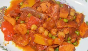 chickpea, sweet potato, pepper and pea curry on a plate
