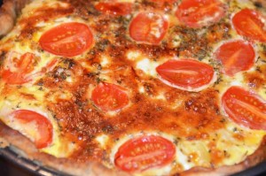 quiche with tomatoes on top