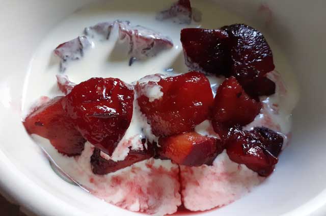 red-stewed-plums-in-bowl-with-cream