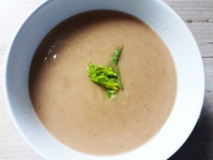 Cauliflower and fennel soup in a white bowl