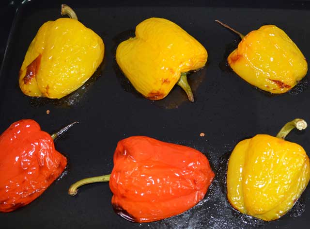 yellow and red pepper halfs on a baking tray