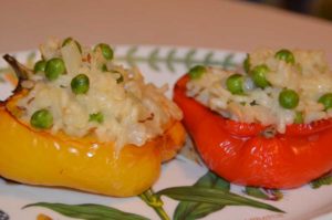 red and yellow half pepper stuffed with rice and peas