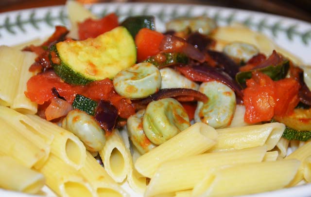 broad beans, courgettes, tomatoes, onions on a bed of pasta