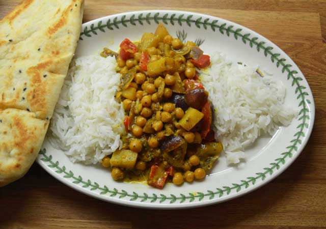Vegetarian Curry Recipe with chickpeas and chopped potatoes on a bed of rice