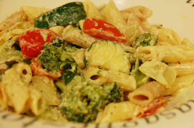 vegetables in a creamy sauce on a bed of penne pasta