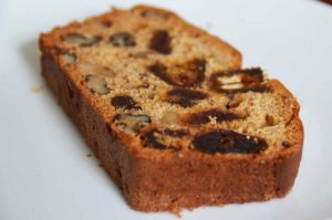 slice of cake showing dates and walnuts in the cake