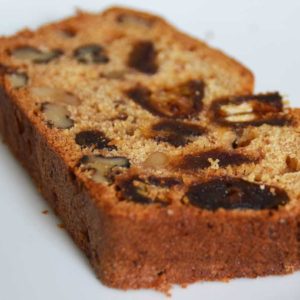 slice of cake showing dates and walnuts in the cake