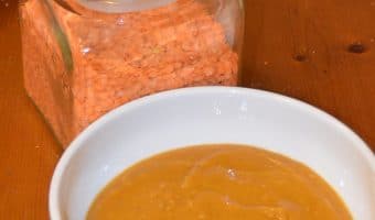 bowl of lentil soup with jar of red lentils