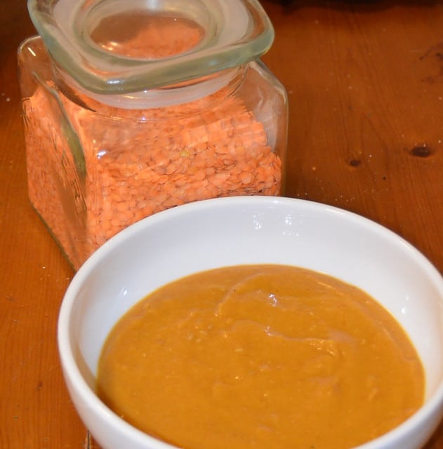 bowl of lentil soup with jar of red lentils