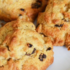 three rock cakes with sultanas on a plate