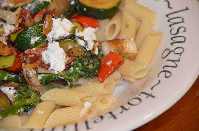 purple sprouting broccoli and pepper with goats cheese on a bed of penne pasta