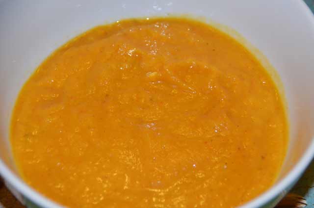 carrot and leek soup ready to eat in a white bowl