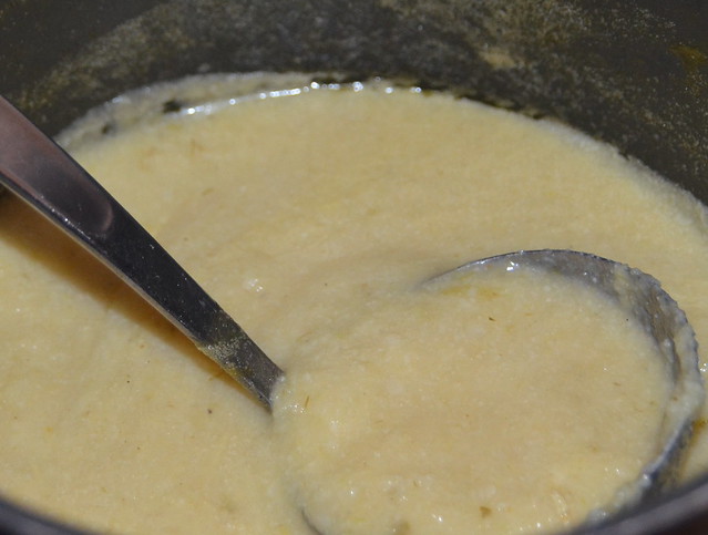 cream coloured cauliflower and leek soup soup in a pan with ladle