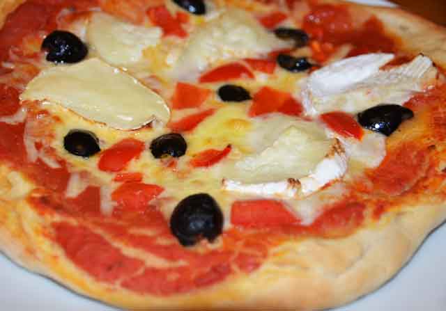 whole pizza with goats cheese and olives topping