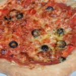 whole home made pizza with cheese tomatoe and olives