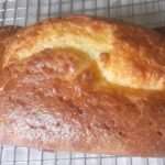 whole lemon cake on cooling rack