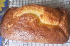 whole lemon cake on cooling rack