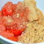 portion of rhubarb and strawberry crumble in a bowl