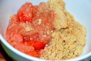 portion of rhubarb and strawberry crumble in a bowl