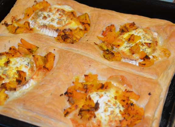 Large pastry piece with squash and goats cheese in each of 4 squares