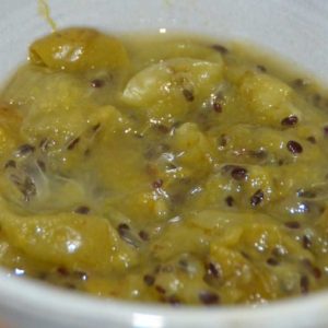 grey bowl with stewed green gooseberries and dark seeds