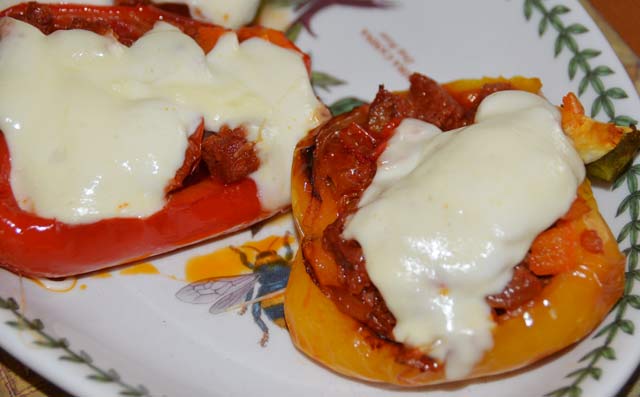red and yellow pepper halves with chorizo filling topped with cheese