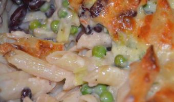 peas and beans in a cheesy sauce on pasta
