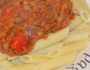 lentil bolognese tomato sauce on a bed of penne pasta