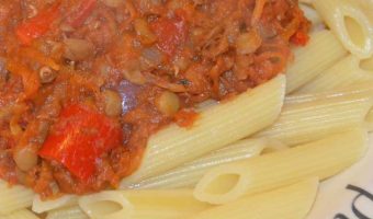 lentil bolognese tomato sauce on a bed of penne pasta