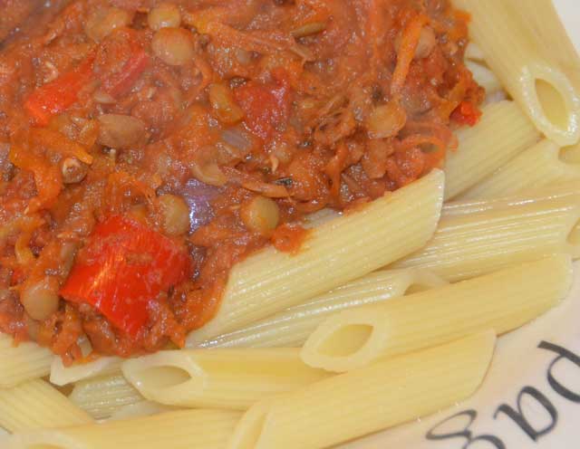 lentil bolognese tomato sauce on a bed of penne pasta