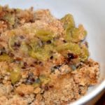portion of stewed green gooseberries with crumble topping