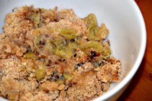 portion of stewed green gooseberries with crumble topping