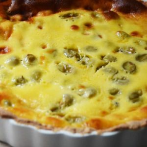 whole yellow tart with green gooseberries showing