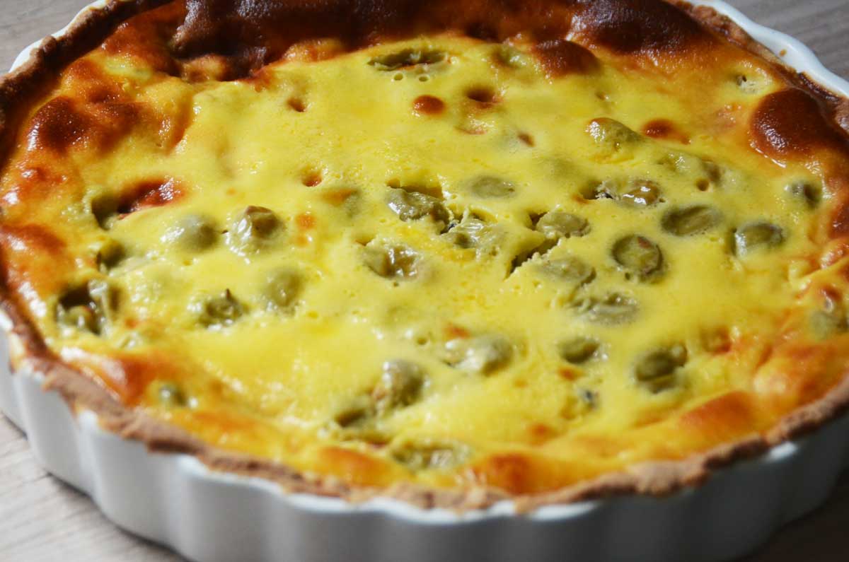 whole yellow tart with green gooseberries showing