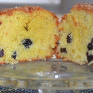 pineapple coconut cake sliced down the middle showing fruit and pineapple