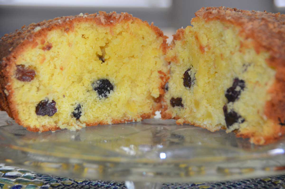 pineapple coconut cake sliced down the middle showing fruit and pineapple