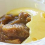 stewed rhubarb with yellow custard being poured on