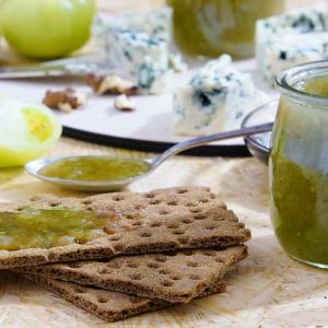 jar of chutney with crispbreads and cheese
