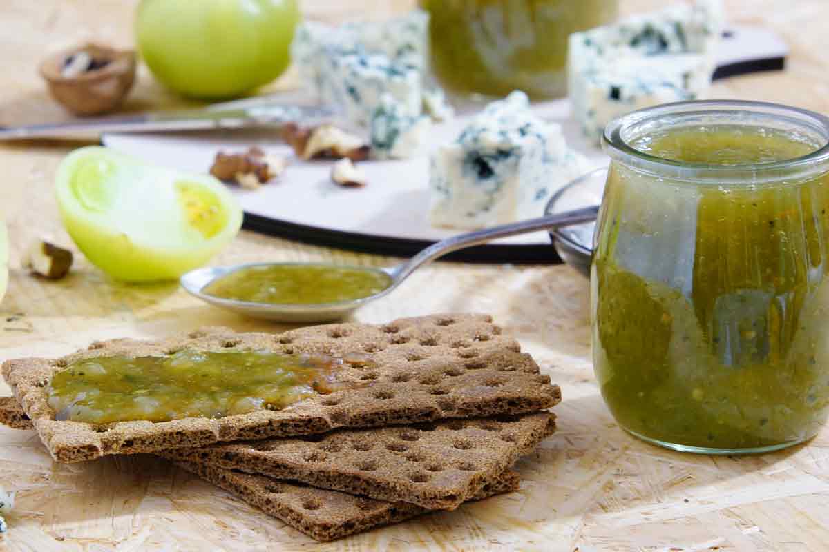 jar of chutney with crispbreads and cheese