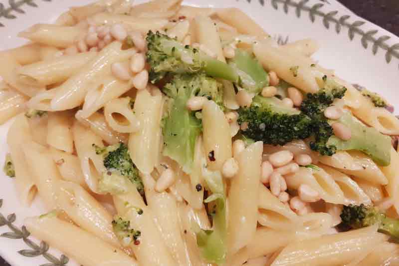 penne pasat with broccoli and pine nuts in a cream sauce