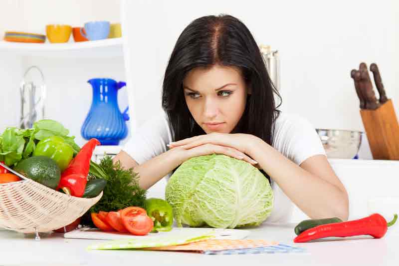 woman with cabbage looking quizzical