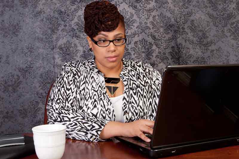 woman working with laptop and cup of coffee