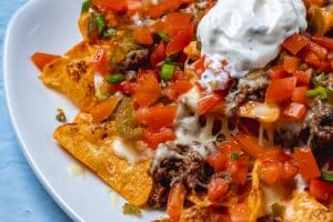 view of nachos with mince, tomato, cheese, jalepeno, pepper and sour cream