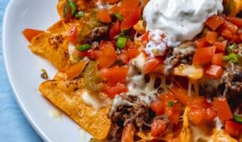 view of nachos with mince, tomato, cheese, jalepeno, pepper and sour cream